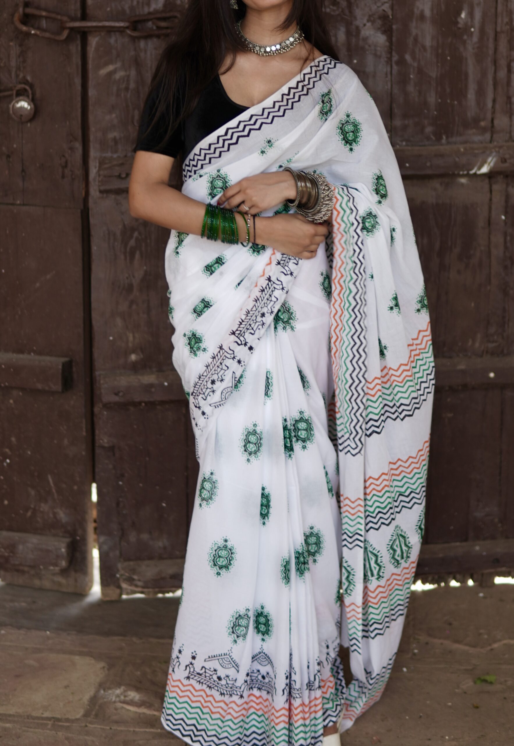 : Hand block printed mul cotton saree with green floral motif and geometric border design