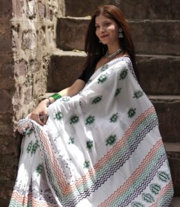 Folded hand block printed mul cotton saree showing multiple motifs and design pattern