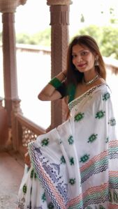Close-up detail of hand block printed green floral motif on mul cotton saree