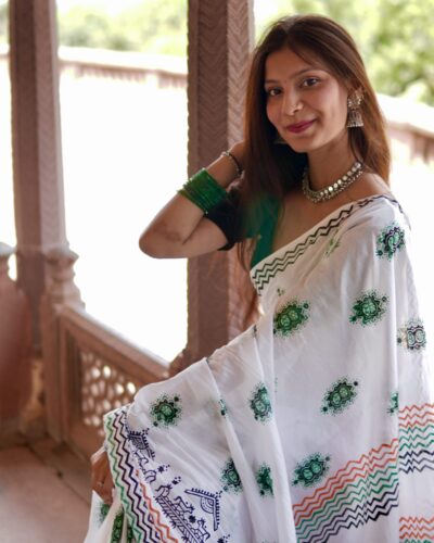 Close-up detail of hand block printed green floral motif on mul cotton saree