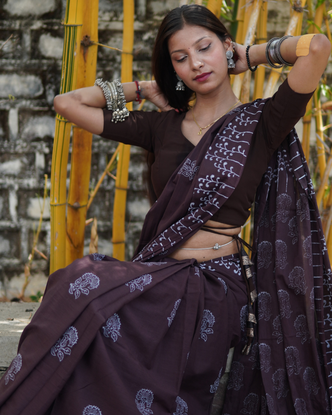 Midnight Plum Hand Block Printed Mul Cotton Saree - Lifestyle View Model wearing Midnight Plum Hand Block Printed Mul Cotton Saree with traditional floral motifs by Shree Giriraj Sarees