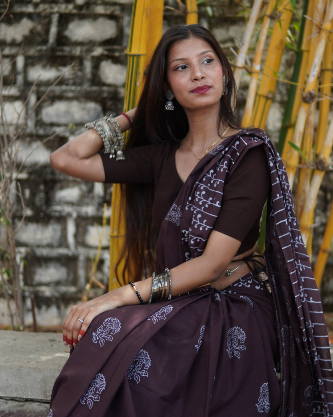 Midnight Plum Hand Block Printed Mul Cotton Saree - Editorial Lifestyle View Model wearing Midnight Plum Hand Block Printed Mul Cotton Saree in an elegant lifestyle portrait