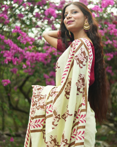 Model wearing Ivory Hand Block Printed Mulmul Cotton Saree with horse motifs
