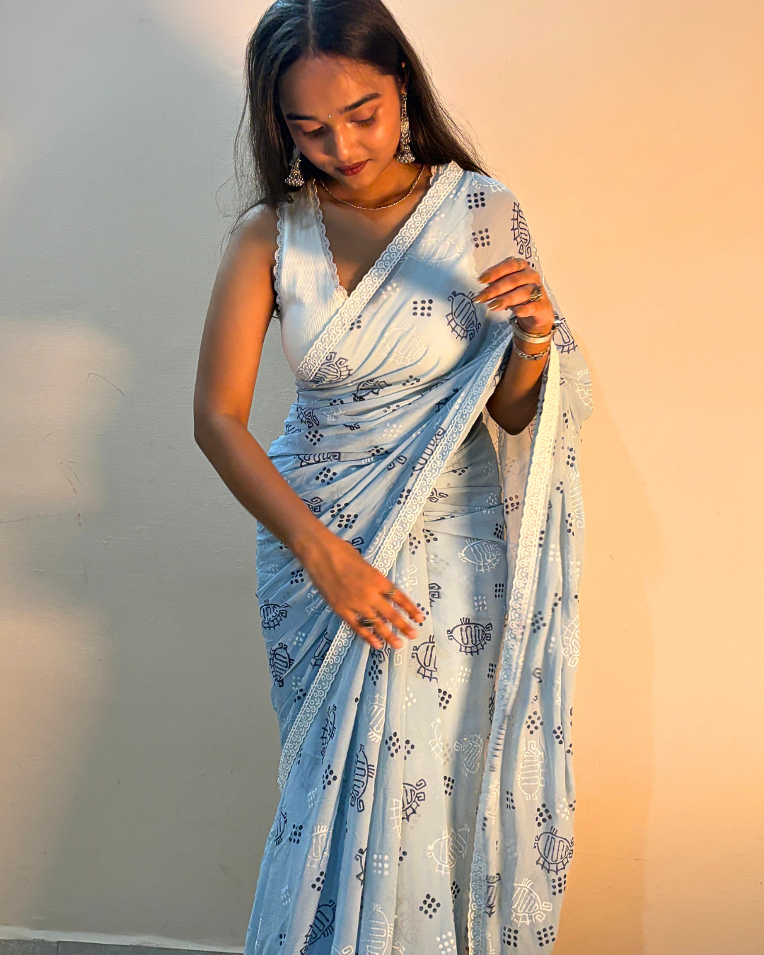 Light blue georgette saree with blue and white printed motifs