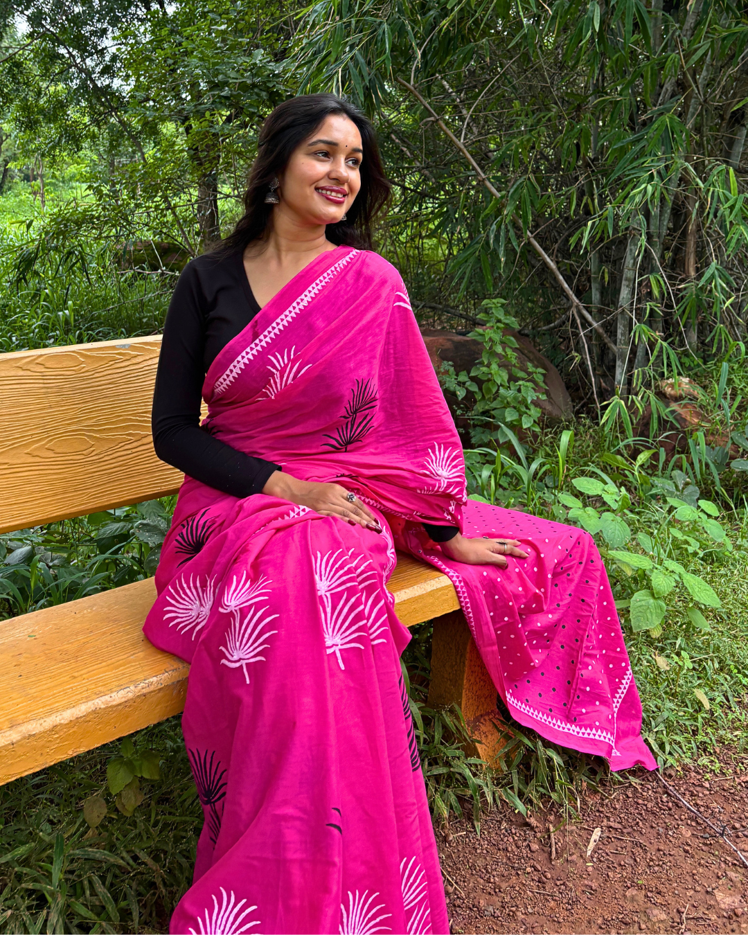 Pink Mulmul Cotton Saree Styled Look Woman wearing a pink mulmul cotton block print saree with white floral motifs