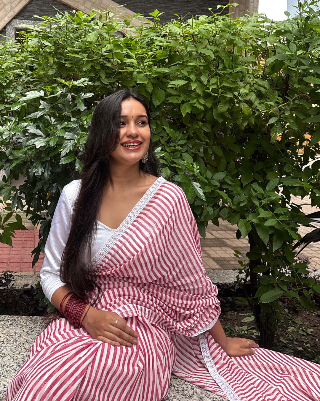 Pink and White Striped Georgette Saree Pink and white striped Georgette saree worn by a woman